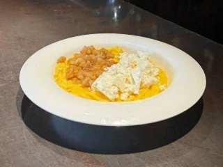 Carpathian banosh with salted cheese and cracklings
