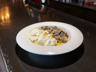 Carpathian banosh with mushrooms and salted cheese